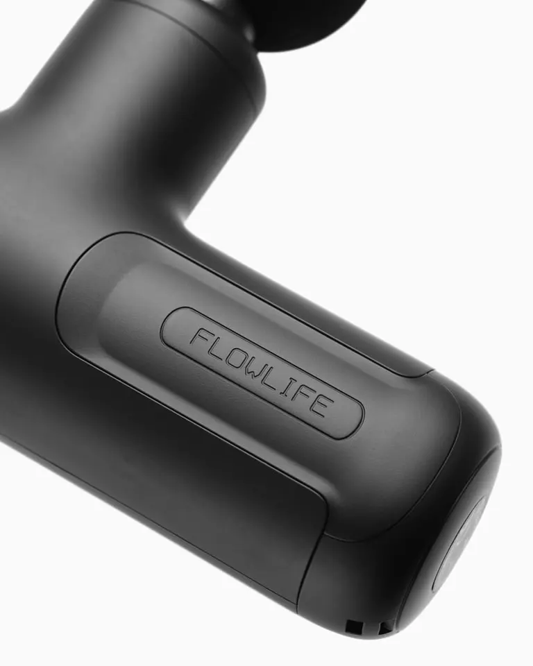 Close-up of the matte black Flowgun Air handle featuring the engraved Flowlife logo and a round massage head.