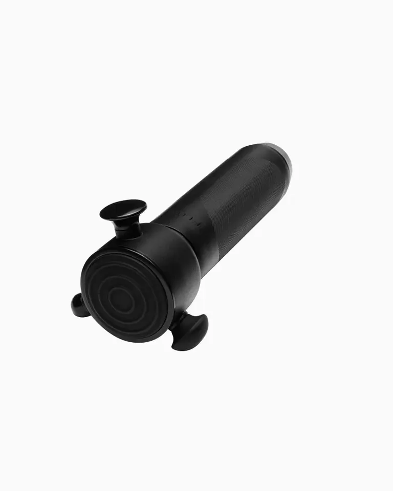 Angled view of the black Flowsonic Pro, a high-frequency vibration therapy tool designed for gentle surface-level relief.