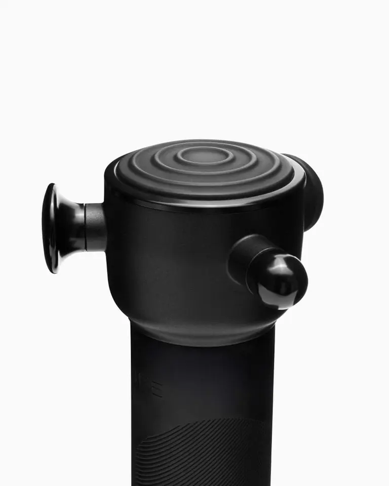 Close-up of the matte black Flowsonic Pro+ showing precision attachment heads and a concentric ring top design.