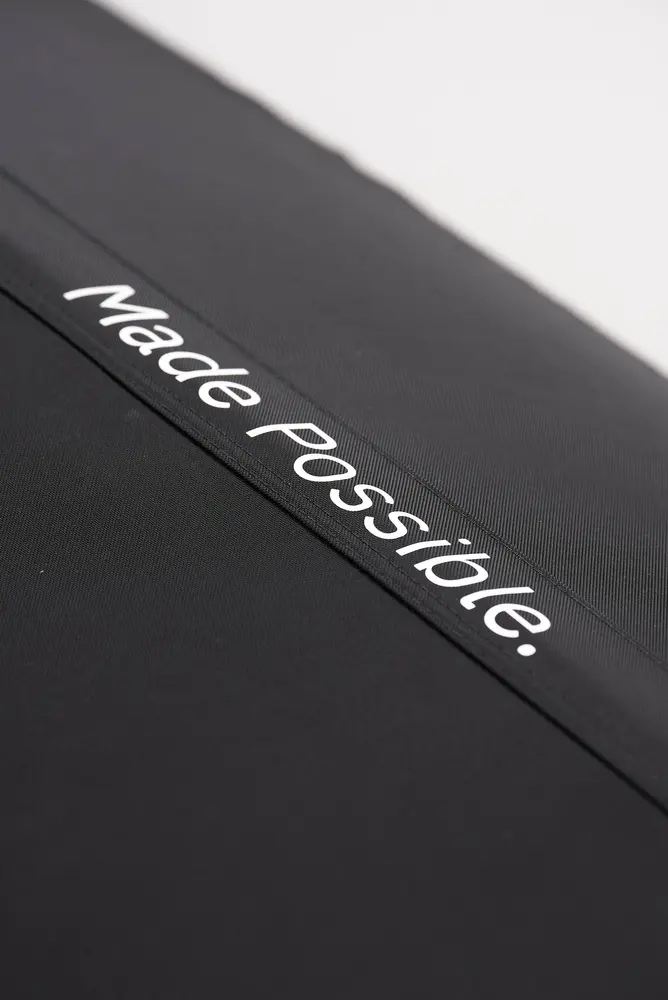 Close-up of the black Flowchamber Oxygen Elite 170 Soft-Shell fabric featuring white "Made Possible." branding.