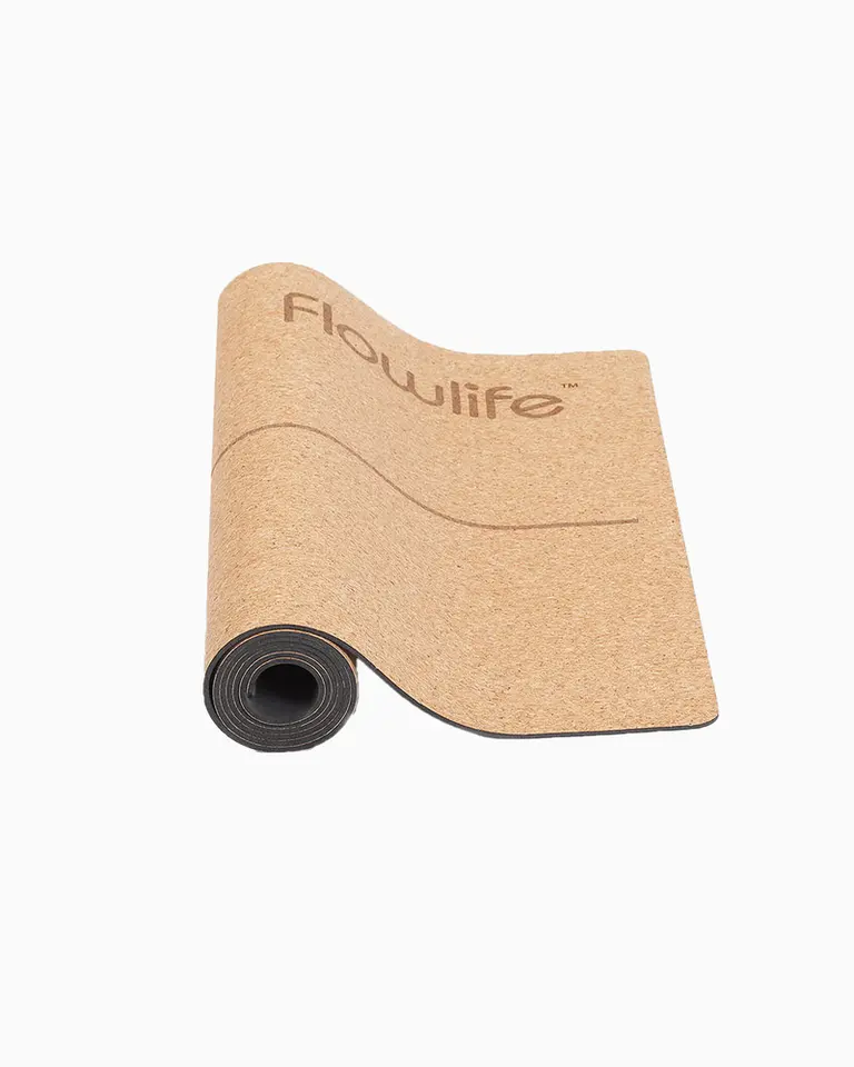 Flowmat natural cork yoga mat shown partially unrolled, featuring a high-grip surface and dense rubber base.