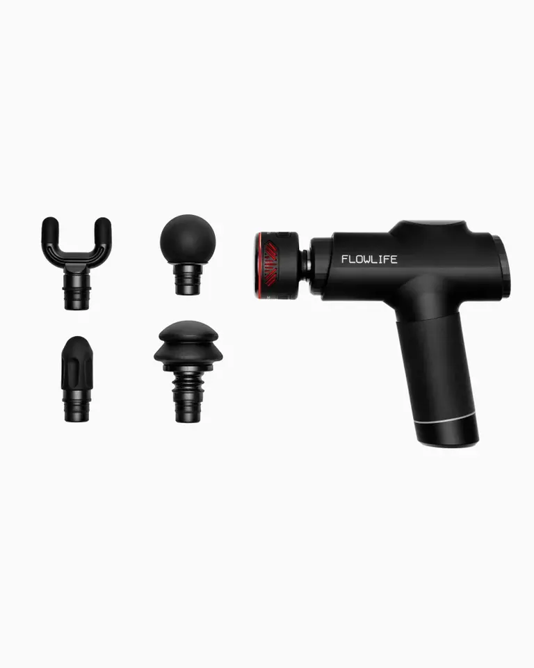 Black Flowgun Heat in a studio side view with four interchangeable heads for percussive and heat-assisted recovery.