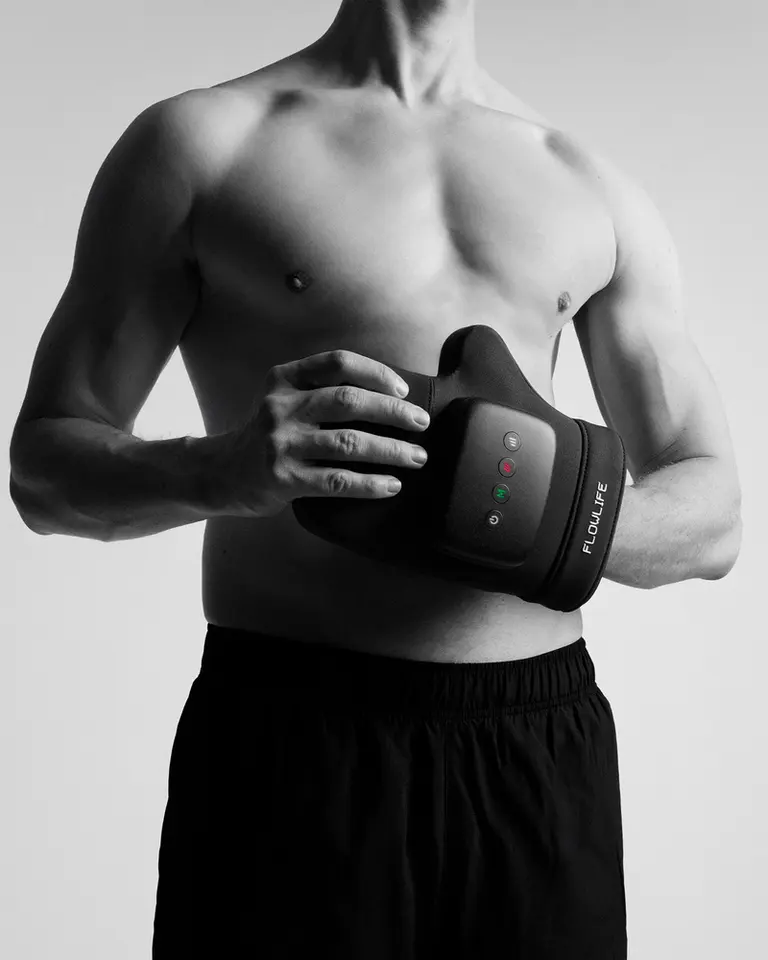 Flowpression Hand air compression massager held by a man, featuring a black ergonomic design and control panel.