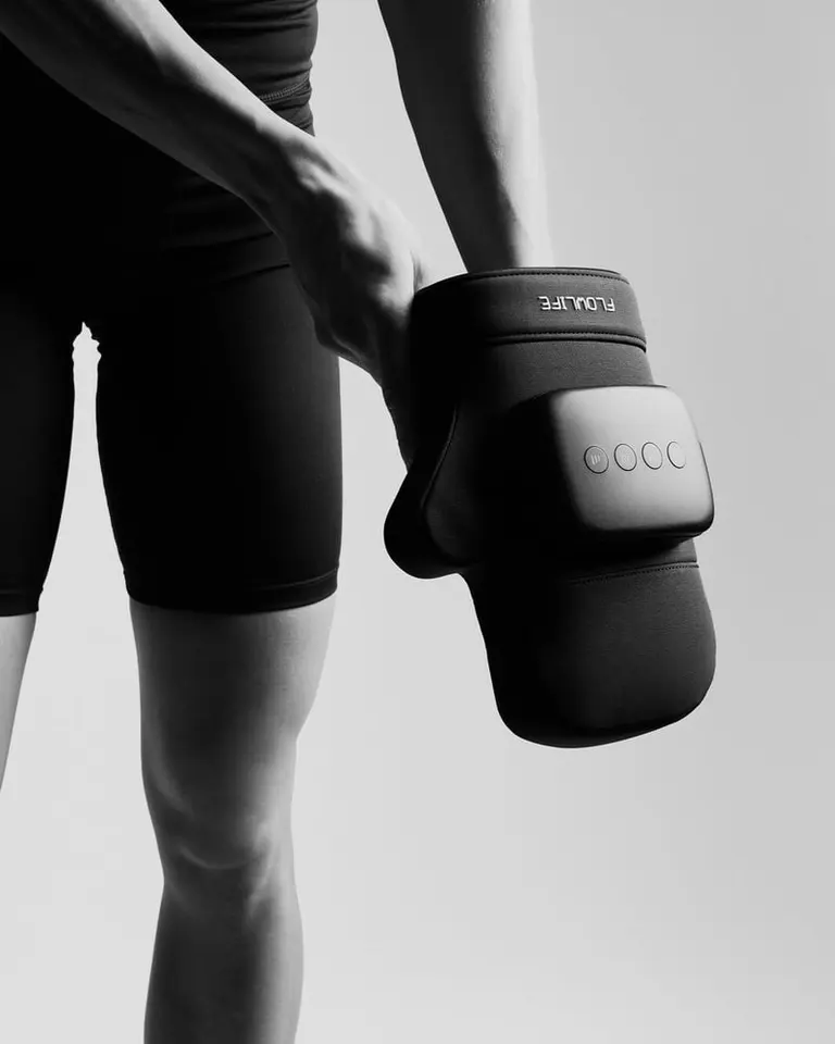 Black Flowpression Hand compression massager featuring an ergonomic cuff and integrated control buttons for hand recovery.