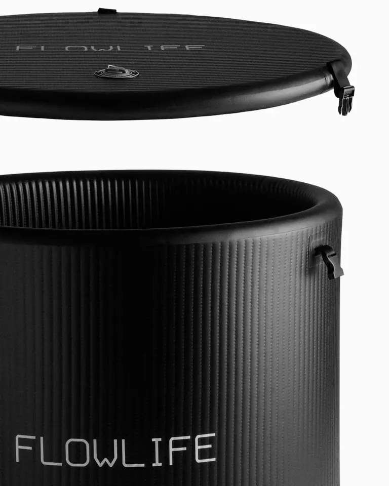 Black Flowplunge Pro cold plunge tub with textured drop-stitch walls and a matching insulated lid for recovery.