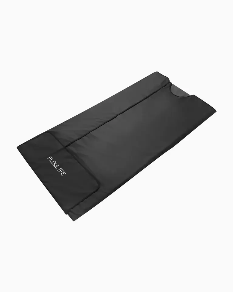 The black Flowsauna Blanket shown unfolded, using far infrared heat to support muscle relaxation and tissue recovery.