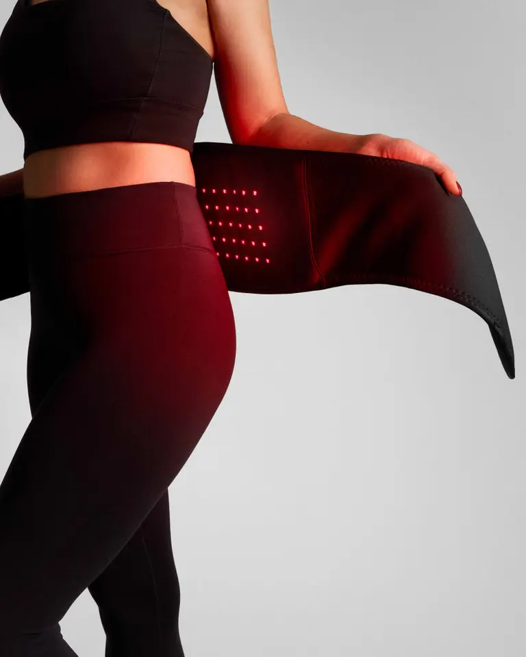 Flowtherma Belt in black, featuring an integrated red-light therapy grid for targeted heat and lumbar recovery.