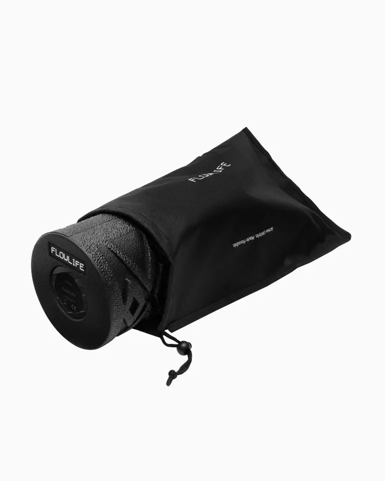 Flowroller Pro vibrating foam roller with textured black EPP foam, shown in its black drawstring carry bag.