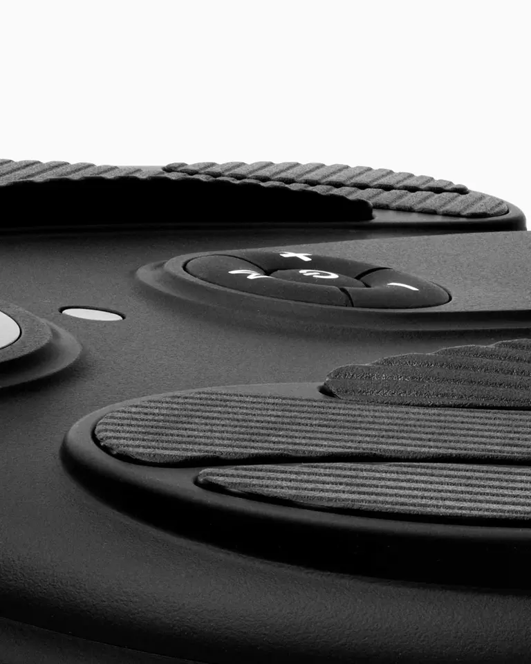Close-up view of the black Flowtens Feet unit, highlighting the textured foot pads and integrated control buttons.