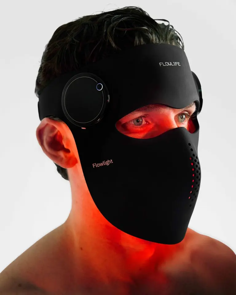 Side profile of a model wearing the black silicone Flowlight Laser Mask Ultra with red light therapy illumination.
